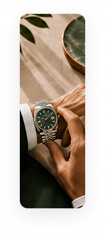 Luxury watch with green dial on wrist